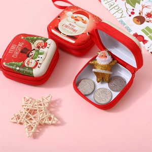 Macro view of Christmas tinplate square coin purses with festive zipper detail