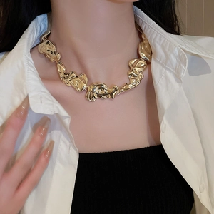 Close-up of golden irregular metallic block necklace with polished choker design detail