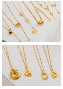 Detailed display of gold titanium necklaces featuring butterfly and floral pendants