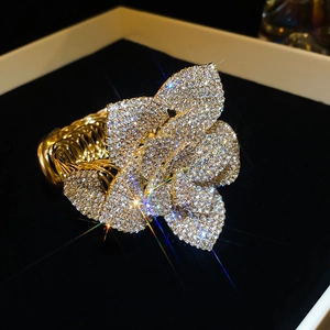 Detailed macro view of the sparkling floral crystal cuff bracelet in a gift box