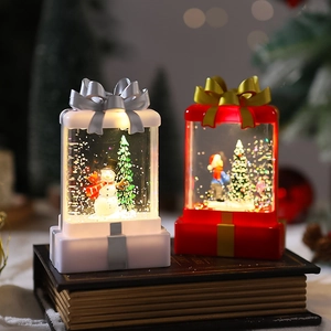 Close-up of LED lit Christmas snow globe lanterns with Santa and snowman scenes