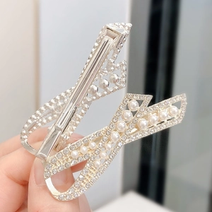 Elegant pair of silver hair clips with bow design, pearls and crystals for women