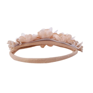 Detail view of handmade chiffon floral baby headband with elastic nylon band in soft pink