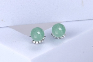 Detailed close-up of light green Aventurine stud earrings with silver diamond accents