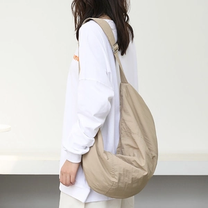 Japanese style khaki nylon crescent crossbody bag shown on model for casual look