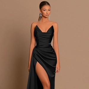 Detail of the elegant black satin fabric showing the deep V-neckline and draped waist design