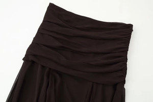 Detailed view of layered horizontal ruffles on semi-transparent dark chiffon skirt