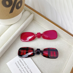 Elegant acetate bow hair clips in rose red and checkered patterns in a gift box