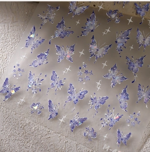 Detail of laser butterfly nail stickers with lilac purple accents and sparkling glitter