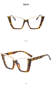 Detail view of tortoiseshell cat-eye glasses frame with golden V-shaped metal accents