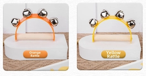 Close-up of orange and yellow montessori baby rattles with wooden handles and metal bells