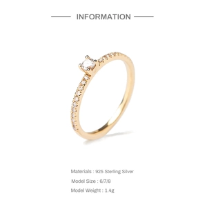 Macro detail of S925 sterling silver ring with pavé diamonds and sleek gold plating