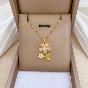 Titanium steel gold necklace with sparkling floral pendant and pearl in beige jewelry box