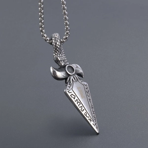 Detailed close-up of a stainless steel snake-head dagger pendant with viking runes engraving