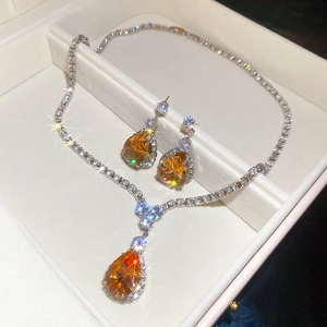 Macro detail of amber teardrop jewelry set with necklace and earrings in a luxury box