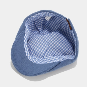 Navy blue knit newsboy cap for women featuring a plaid cotton lining and soft texture