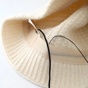 Cream knit bucket hat for women with interior adjustable drawstring and soft texture