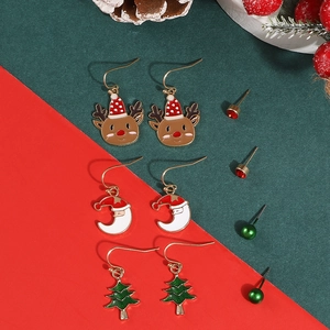 Detailed set of Christmas earrings including reindeer, trees, and santas on festive background