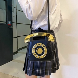Detailed view of creative retro phone-shaped crossbody bag featuring gold dial sequins