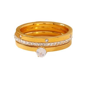 Three-piece golden stainless steel ring set with zircon inlay on white background