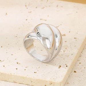 Macro shot of polished silver wide band ring with irregular liquid metal texture