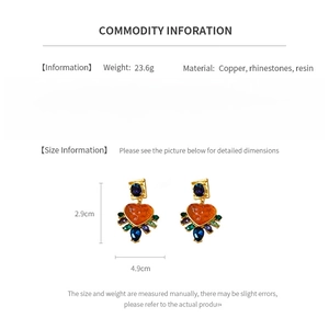 Detailed size and material chart for vintage rhinestone heart earrings in white backdrop