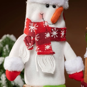 Cute snowman Christmas wine bottle cover with red knitted scarf and carrot nose decoration