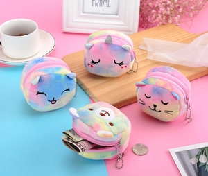 Colorful tie-dye plush animal coin purses with embroidery and metal chains on a tray