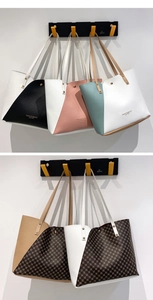 Detail of a color-block tote bag with diagonal stitching and long shoulder straps