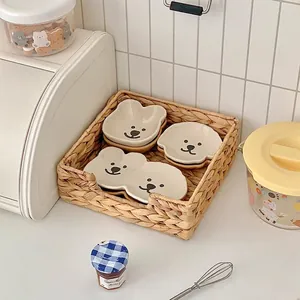Cute bear and puppy ceramic sauce dishes in a woven basket for home dining setup