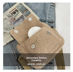 Detail of beige fleece crossbody bag showing capacity of the front magnetic pocket