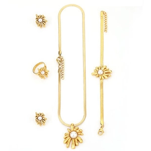 Detailed set of gold sunflower jewelry with white pearl centers on white background