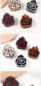 Detailed macro view of vintage resin rose hair claws in burgundy and cream white