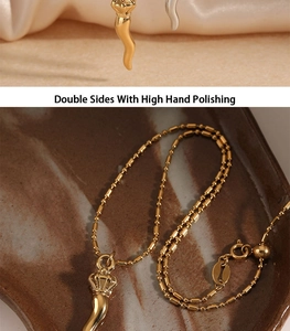 Detailed macro shot of golden Cornicello horn pendant with high hand-polished finish