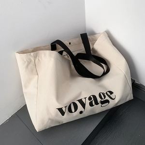 Minimalist large canvas tote bag with black voyage print and handles for travel