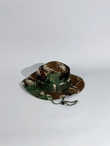 Detail view of camouflage boonie hat with adjustable chin strap and wide sun brim