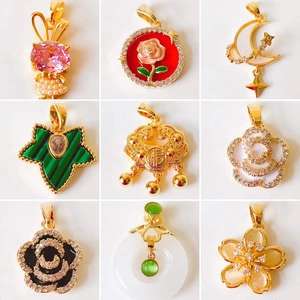 Detail shots of assorted 18k gold pendants featuring rose, clover, and pearl designs