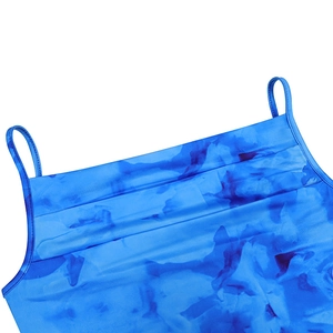 Detail of blue tie-dye cropped top showing neckline and delicate shoulder straps