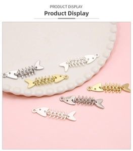 Detailed view of silver and gold moveable fish bone pendants for DIY jewelry crafting