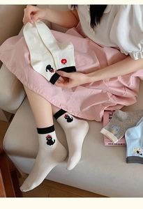 Detail of cartoon animal embroidery and ribbed color-block cuffs on cotton socks