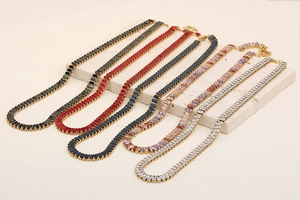 Detail of five 18K gold plated tennis necklaces with colorful rectangular cut crystals