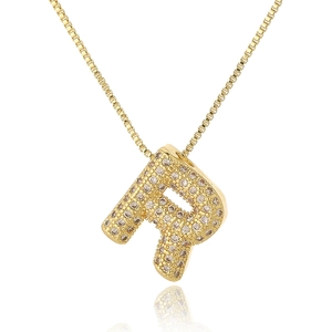 Close-up of golden letter P pendant with micro-paved cubic zirconia stones and chain