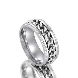 Macro detail of rotating chain structure and gear texture on silver stainless steel ring