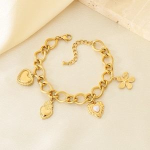 Detail of vintage French style gold cross heart pendant bracelet on elegant silk background