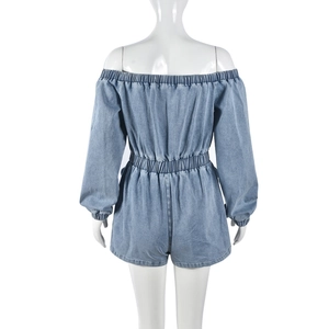 Detail view of the elastic waist and back design of light blue denim romper