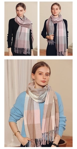 Detail of soft plaid scarf with tassels in Morandi pink and grey checkered wool-like fabric