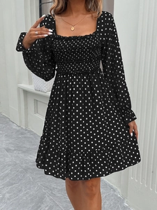 Polka dot dress featuring square neck, elastic bust, and ruffled hem in black and white