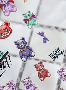 Detailed view of 5D nail art stickers featuring dark bear and bat motifs for Halloween