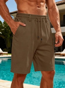 Detail of men's quick-dry textured shorts with drawstring waist in a resort setting