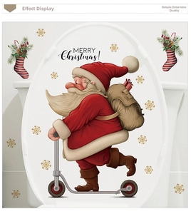 Detail of Santa Claus on scooter toilet sticker with golden snowflakes and Merry Christmas text